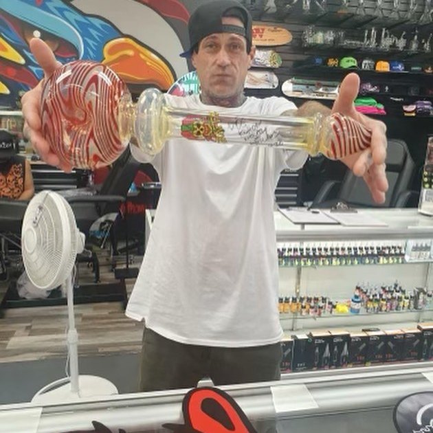 Customer at a Las Vegas smoke shop holding the Big Ass Pipe