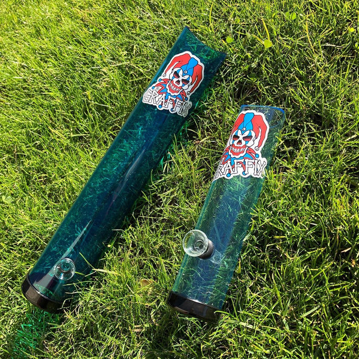 Two green acrylic Graffix tubes on the grass