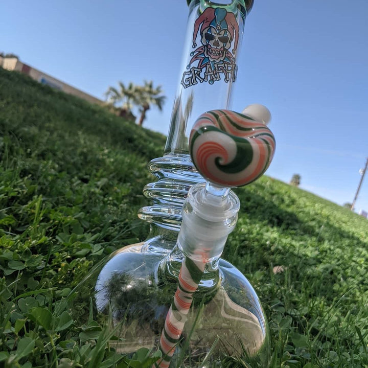 Graffix glass beaker with coil and wig-wag bowl on a grassy hill